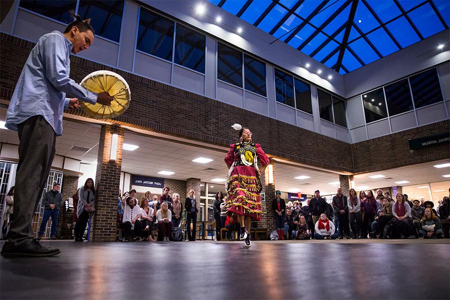 Art and design students and professors watch a performance in the Center of the Arts on the University of Wisconsin Whitewater campus.